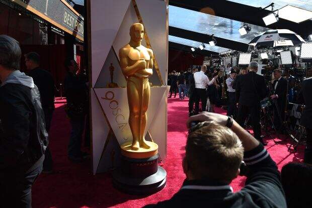 Photographers and TV crews get ready on the red carpet a few hours before the