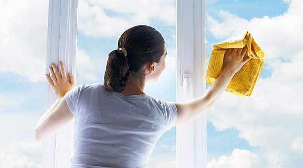 young woman washing windows