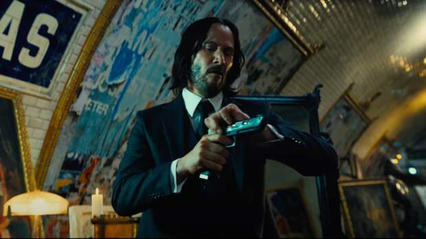 keanu reeves loading a gun in john wick 4