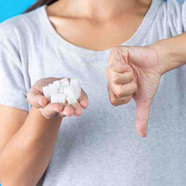 world-diabetes-day-hand-holding-sugar-cubes-thumb-down-another-hand