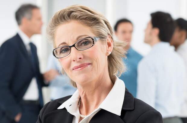 Someone wearing glasses and slightly smiling at the camera.