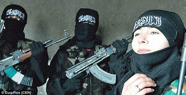 Sabina, pictured beside jihadists wielding Kalashnikov rifles, somewhere in Syria or Iraq