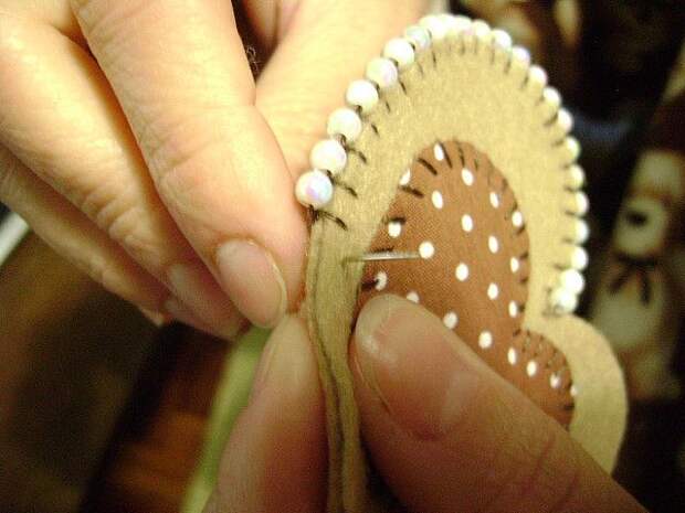Smart: add a bead to blanket stitches for a pretty beaded boarder.