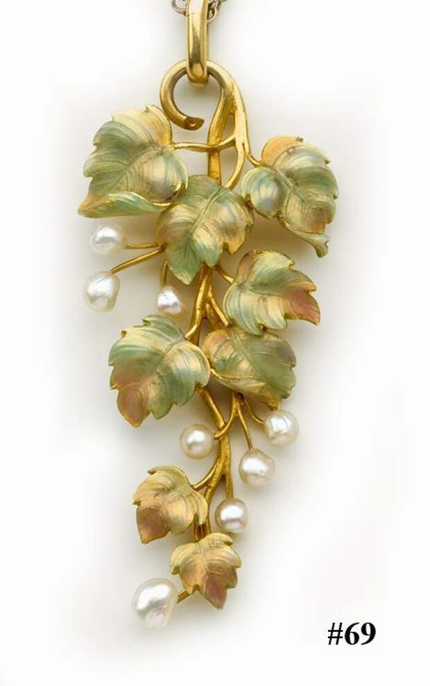 Enamel, natural pearl and gold vine pendant and chain. English. This is a wonderful example of a piece of Art Nouveau jewelry combining beautiful pastel toned enamel with peg set natural pearls on intricate carved yellow gold leaves. Suspended from a finely linked yellow gold chain.