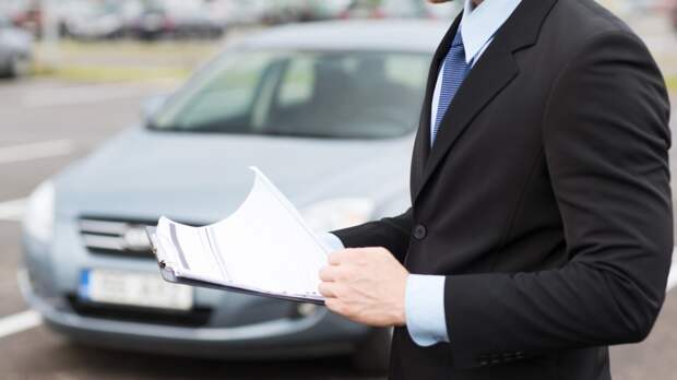 man with car documents outside