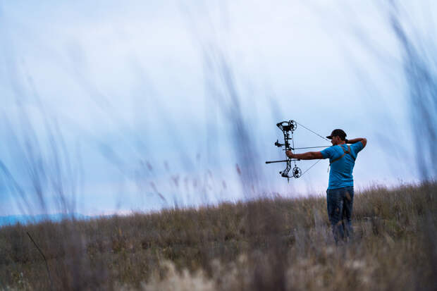 Brett Seng at full draw with his mathews hunting bow target practicing