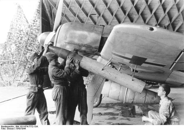 Аэродромные техники заряжают подкрыльевую ракетную установку Wfr. Gr. 21 калибра 210 мм на немецком истребителе Fw-190A Великая отечественая война, архивные фотографии, вторая мировая война