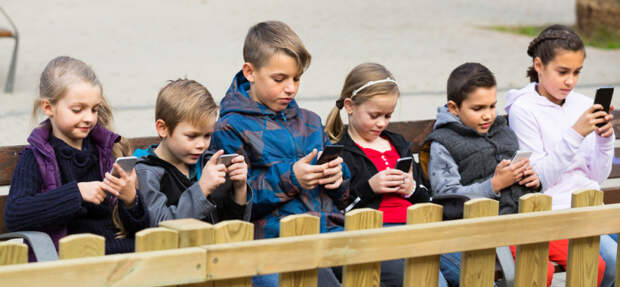 Зависимость от видеоигр: горькая правда, которую должен знать каждый родительGroup of smiling children posing at urban street with mobile devices