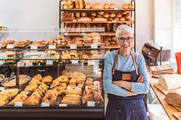 A person in an apron in a bakery.