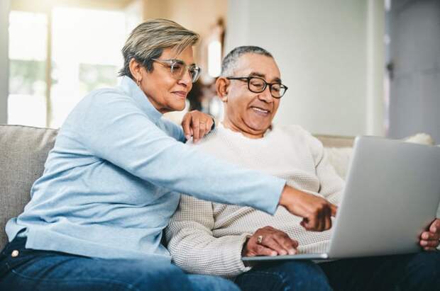 Two people at a laptop.