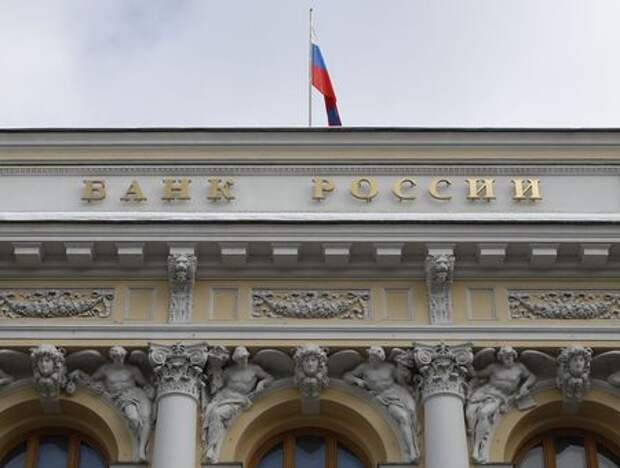 A woman holds a small bottle labeled with a "Coronavirus COVID-19 Vaccine" sticker and a medical syringe in front of displayed Russia flag in this illustration taken, October 30, 2020. REUTERS/Dado Ruvic