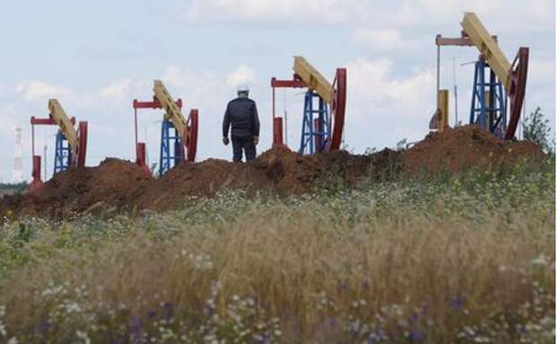 FILE PHOTO: A worker stands in front of pump jacks at the Ashalchinskoye oil field owned by Russia's oil producer Tatneft near Almetyevsk, in the Republic of Tatarstan, Russia July 27, 2017. REUTERS/Sergei Karpukhin/File Photo