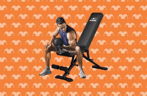 A man sitting on a bench lifting weights