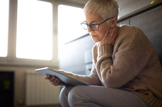Serious person looking at tablet.