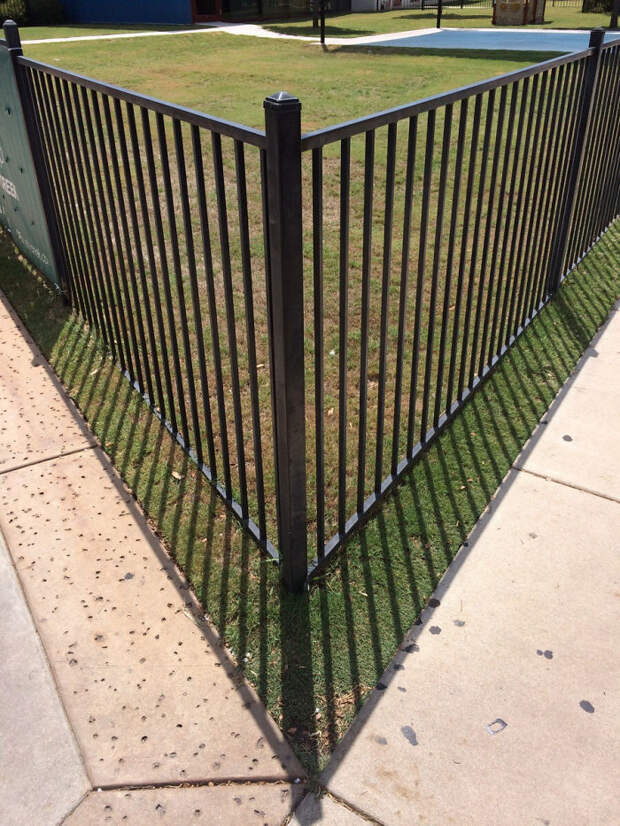 The Shadow From The Fence (Almost) Perfectly Lines Up With The Sidewalk