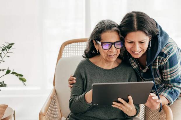 Two people looking at a tablet.