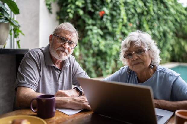 Two people at a laptop.
