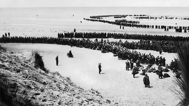 ДЮНКЕРК, 26-29 МАЯ 1940 ГОДА. БРИТАНСКИЕ ВОЙСКА ВЫСТРАИВАЮТСЯ НА ПЛЯЖЕ В ОЖИДАНИИ ЭВАКУАЦИИ. СКРИН С САЙТА ASIATIMES.COM