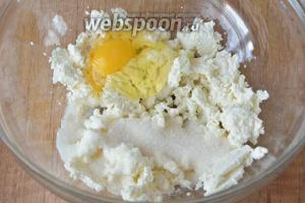 В глубокой миске соединить творог, сахар, яйцо и ванилин. Растереть с помощью венчика или вилки в однородную массу.