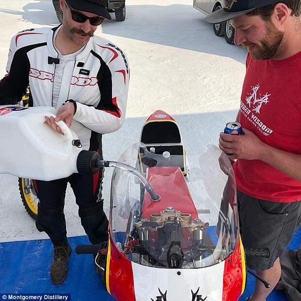 The record-breaking motorcycle is shown having its vodka waste product fuel topped upÂ 