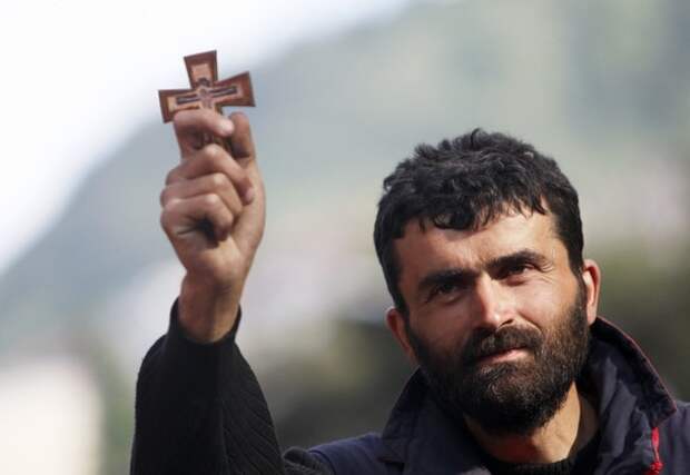 A man holds up a cross during an opposition rally in Tbilisi