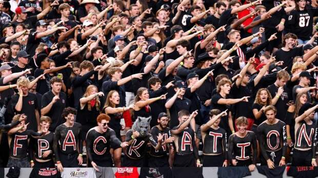 NC State fans cheer on the Wolfpack in the stands.