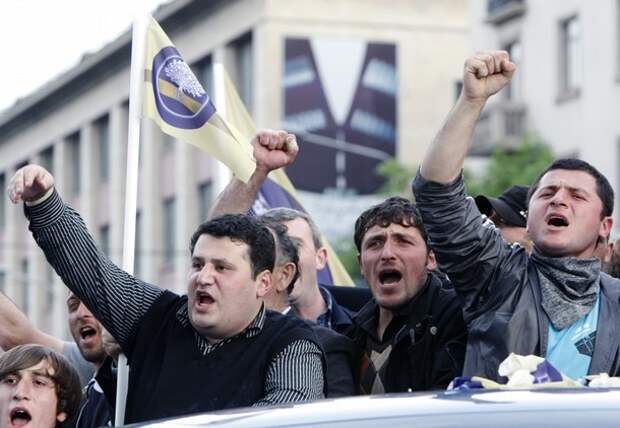Opposition supporters shout slogans during a rally in Tbilisi