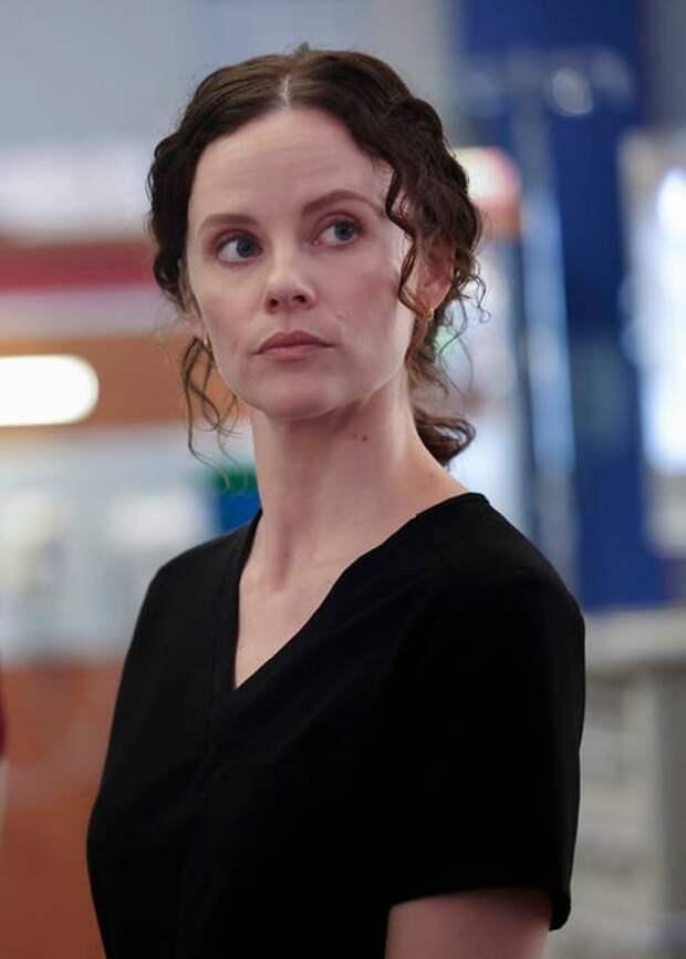 Caitlin Lenox standing and looking into the camera on Chicago Med S10 E1