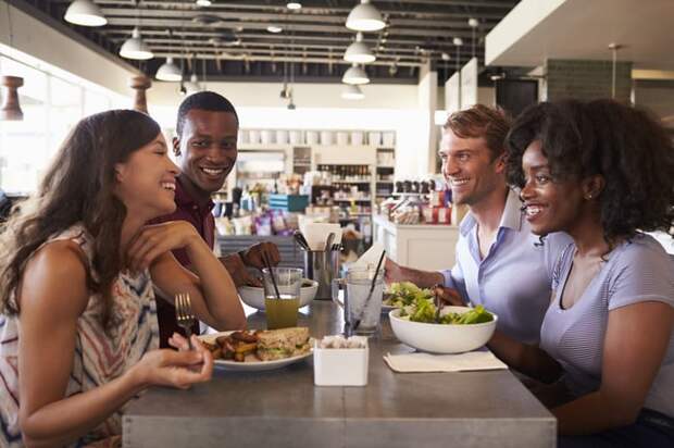 A group of people eat lunch at a restaurant.