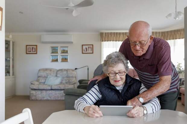 Couple looking at tablet together.