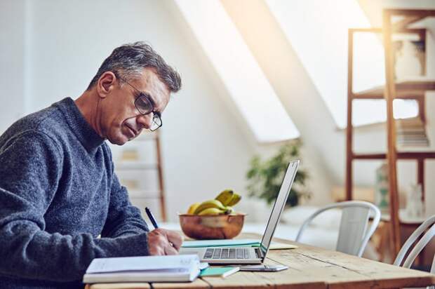 A person at a laptop writing.