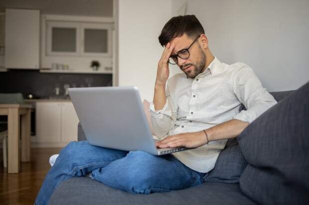 A person on couch with a laptop.