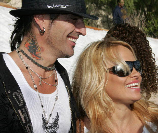 Musician Tommy Lee and actress Pamela Anderson pose at the home of John Paul DeJoria, CEO and co-founder of John Paul Mitchell Haircare Systems, during his annual party to thank movie, television and music star friends and his co-workers for their charitable work on December 24, 2005 in Malibu, California. (Photo by David Livingston/Getty Images)