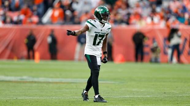 new york jets wide receiver garrett wilson wearing a white jersey and black pants