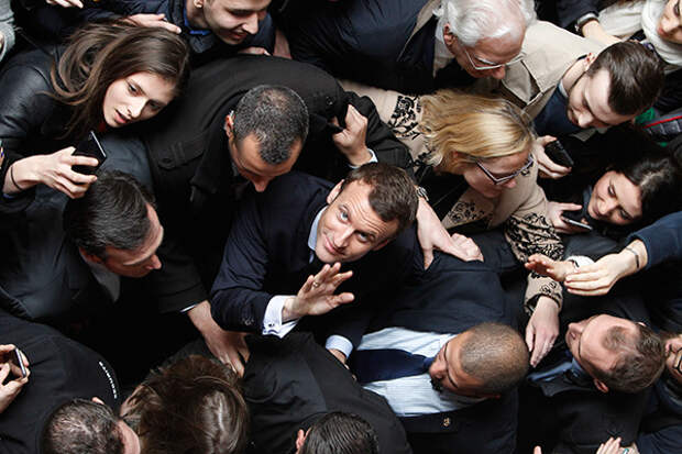 Former French Economy Minister and candidate for the next presidential election, Emmanuel Macron leaves the University of Lille, during a political rally for his movement, En Marche! (Forward!) in Lille, Tuesday, March 14, 2017.