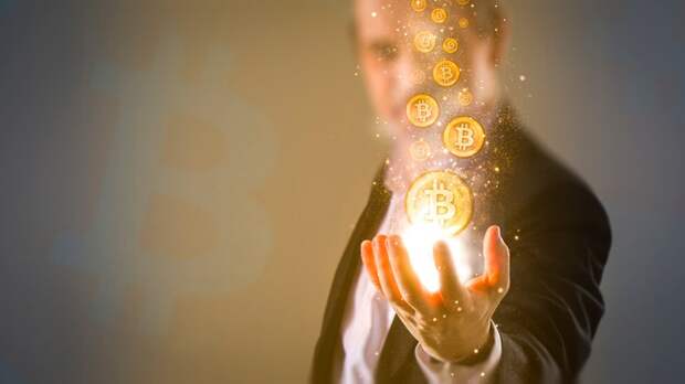 A man holding virtual Bitcoin tokens