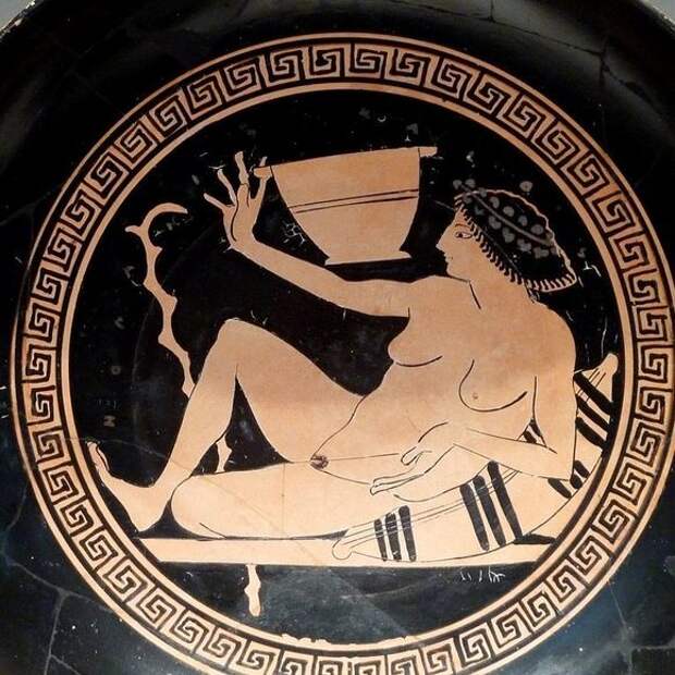 A reclined player getting ready to fling some wine.