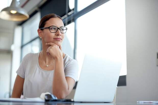 Young woman thinking about investing in the stock market.