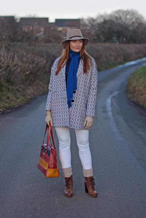 Blue tapestry coat, taupe fedora, white skinny jeans