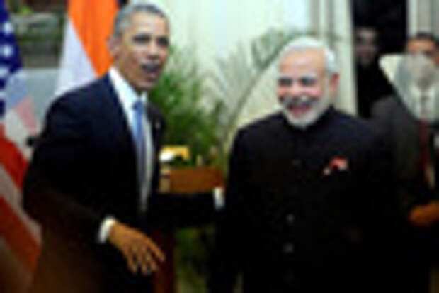 Indian Prime Minister Narendra Modi (L) talks with US President Barack Obama (R) while watching the fly-past during India's Republic Day parade on Rajpath in New Delhi on January 26, 2015. Rain failed to dampen spirits at India's Republic Day parade January 26 as Barack Obama became the first US president to attend the spectacular military and cultural display in a mark of the nations' growing closeness. AFP PHOTO/ PRAKASH SINGH