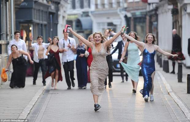A group of friends seemed happy to play up for the cameras as they clattered through the streets after kicking off their heels