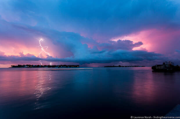 Blue dark pink nature photo of lightning at dusk