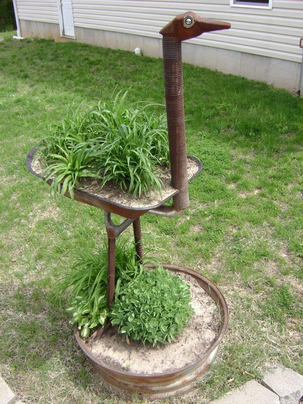 7' tall ostrich, made from reclaimed wheel barrel, garage spring, tractor rim and miscellaneous car parts