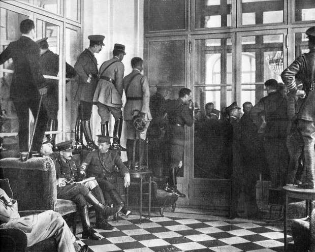 Spectators standing upon tables to get a glimpse of the Versailles Treaty being signed, France, 1919