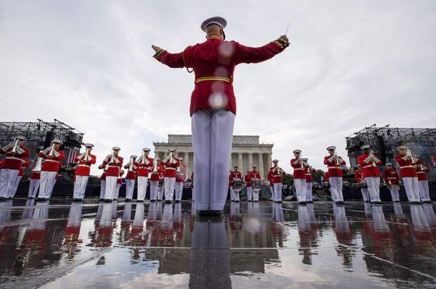 The U.S. Marine Corps Drum and Bugle Corps performs in the rain during an Independence Day, Thursday, July 4, 2019, in Washington.  Alex Brandon, AP.…