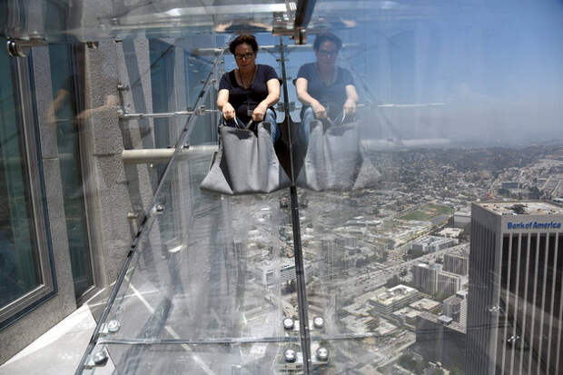 A member of the media rides the Skyslide from the 70th to 69th floor of the U.S. Bank Tower in Los Angeles, California