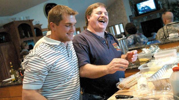 FILE - In this April 18, 2006 file photo, Capt. Rick Quashnick, right, shares a laugh with boat engineer Blake Painter, left, as family and close friends gather at Quashnick's Warrenton, Ore., house to watch the Discovery Channel series