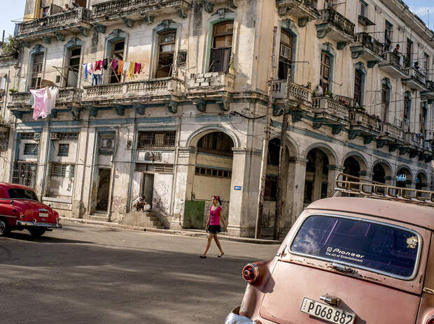 A street in Havana, with its dilapidated but architecturally rich buildings, and vintage American cars