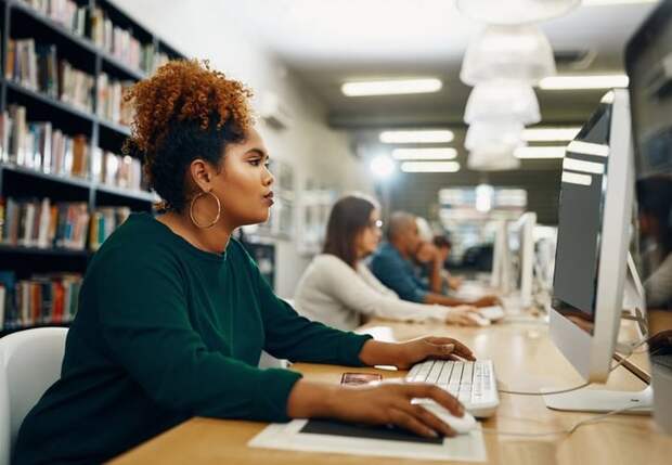 Young woman using laptop at the library