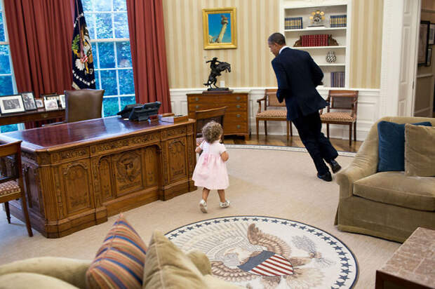 President Barack Obama Runs Around His Desk In The Oval Office With Sarah Froman, Daughter Of Nancy Goodman And Mike Froman, Deputy National Security Advisor For International Economics